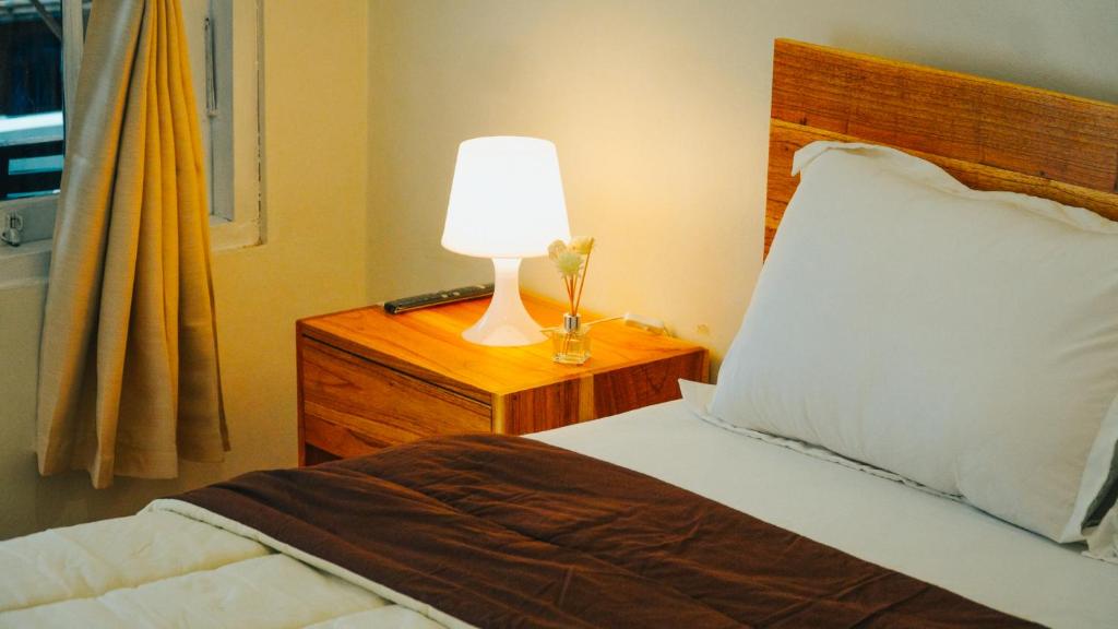 Postel nebo postele na pokoji v ubytování Hotel Gunung Mas Syariah