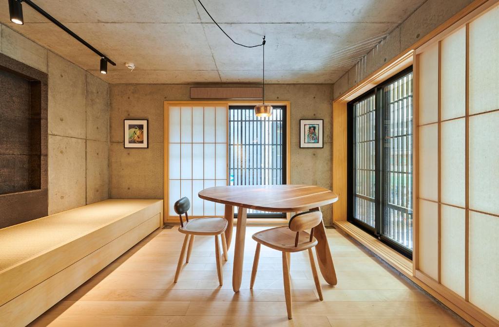 a dining room with a table and two chairs at DELTA Stay in Kyoto