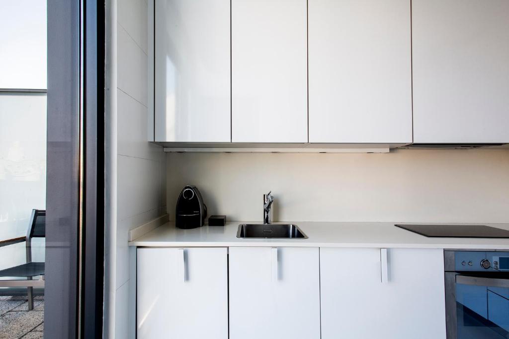 Kuchyň nebo kuchyňský kout v ubytování Suites Avenue