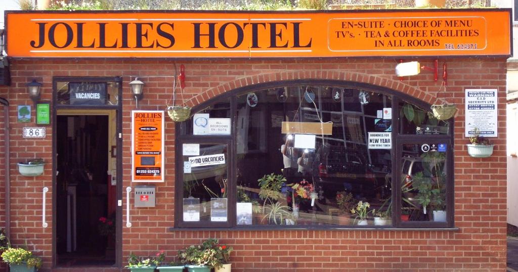 a joliates hotel sign on top of a brick building at Jollies Hotel in Blackpool