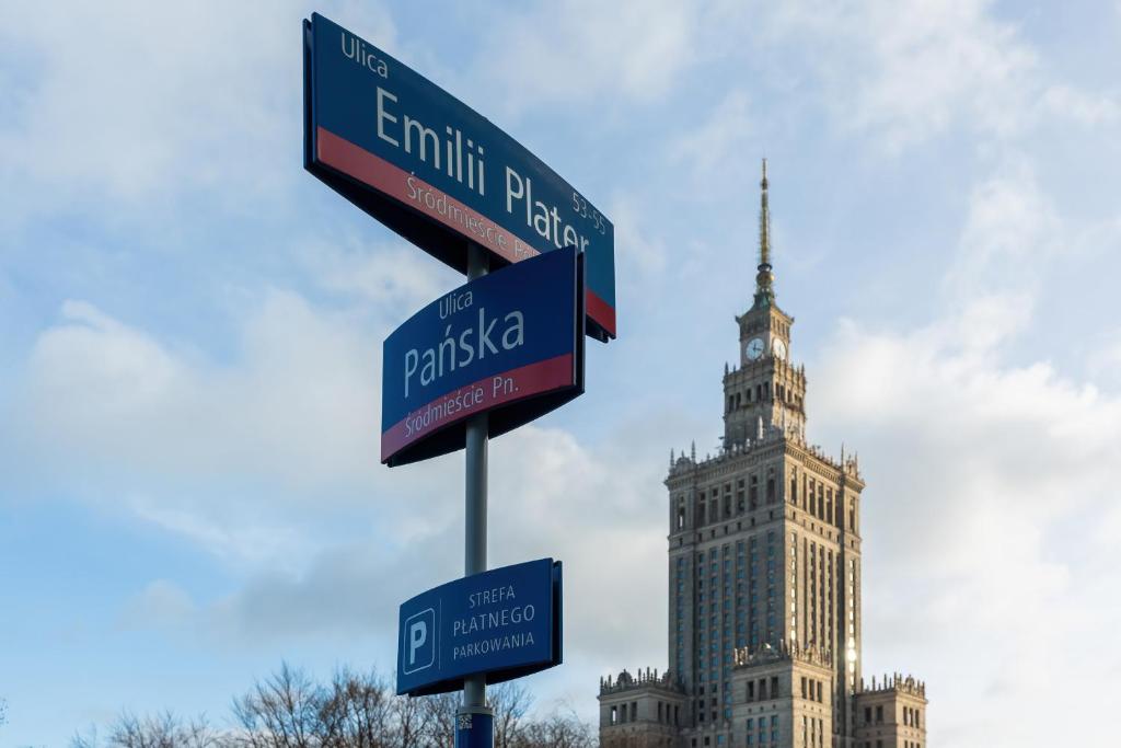 um poste com placas de rua em frente a um edifício em Apartments Pańska Warsaw by Renters em Varsóvia