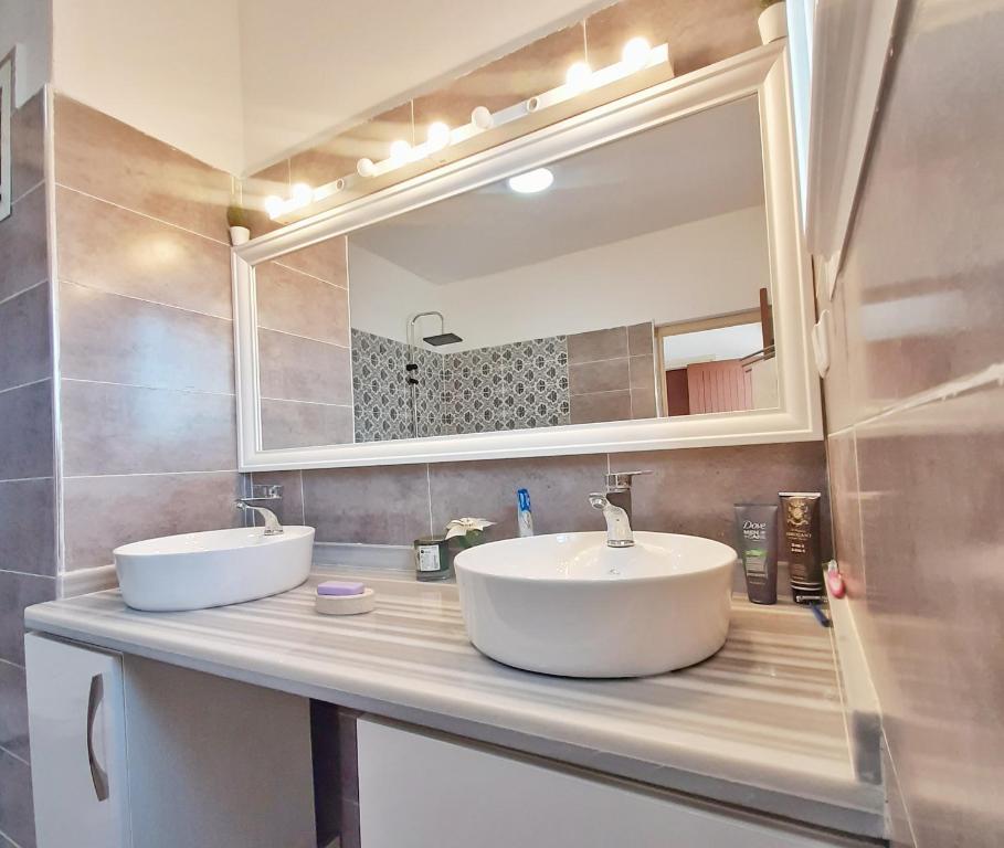 a bathroom with two sinks and a mirror at Rooms To book in Villa House at HostFamily in Rabat in Rabat