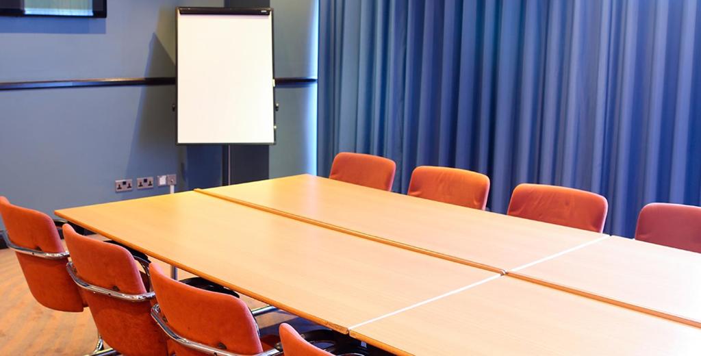 a conference room with a table and chairs at Leonardo Hotel Manchester Central in Manchester