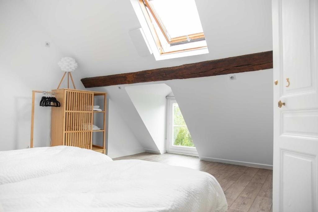 a bedroom with a bed and a skylight at La Demeure de Chemonton in Blois
