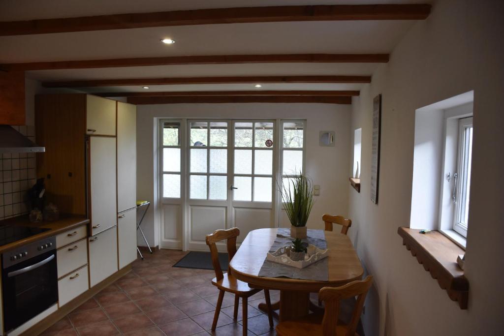 a kitchen with a table and chairs and a window at Ferienwohnung/Haus in Welzin in Damshagen