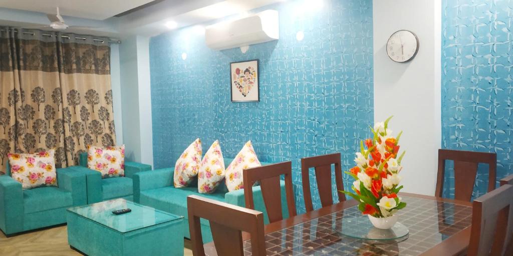 a living room with a couch and a table at 2BHK Short Stay Apartment walking Max Saket ( LIFT +Kitchen+Parking+3 nights min stay) in New Delhi