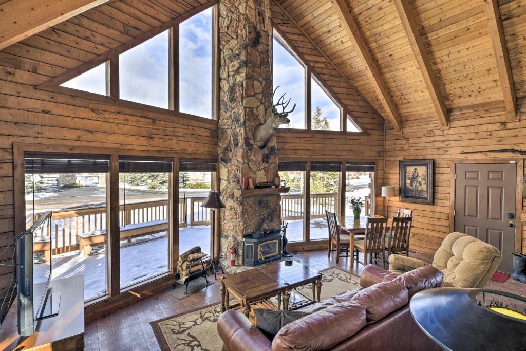 a living room with a couch and a table at Rustic Village Lake Cabin Escape with Deck and Grill! in Pagosa Springs
