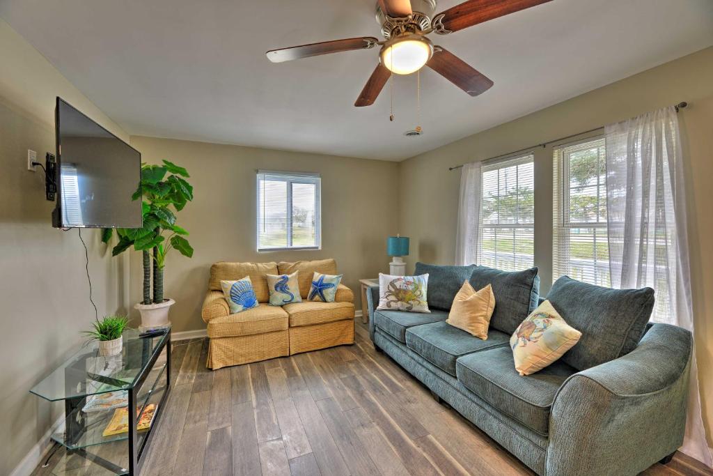 a living room with a couch and a ceiling fan at Luxe Cozy Crab Shack with Porch in Indian Beach! in Atlantic Beach