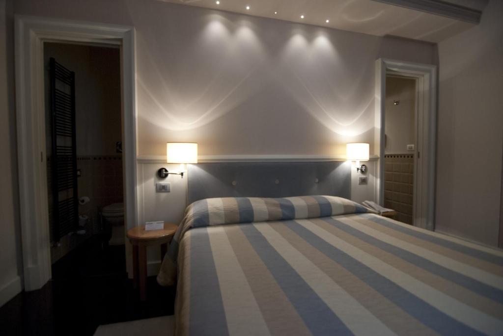 Postel nebo postele na pokoji v ubytování Hotel Patria