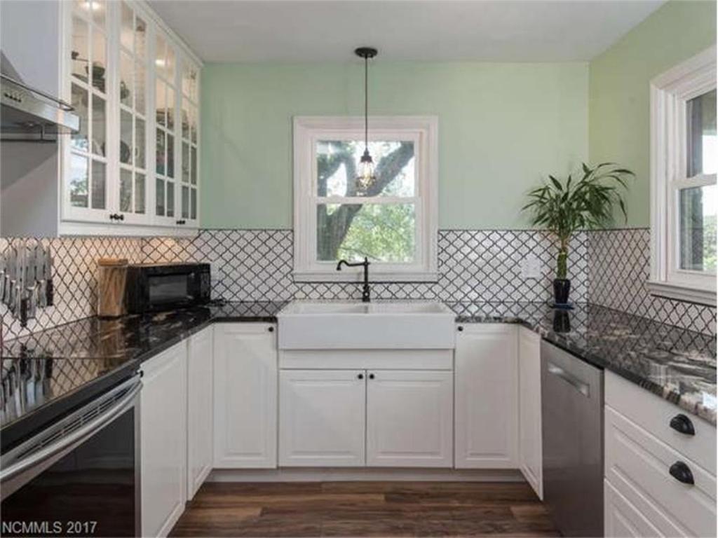 a kitchen with white cabinets and a sink at Cozy Convenience, Private Home 5mins to Biltmore in Asheville
