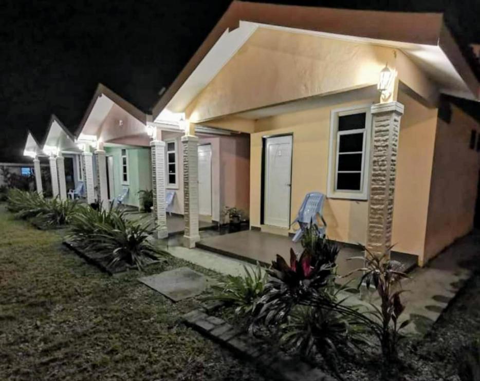 a row of houses at night with lights at ROSA Motel in Pantai Cenang