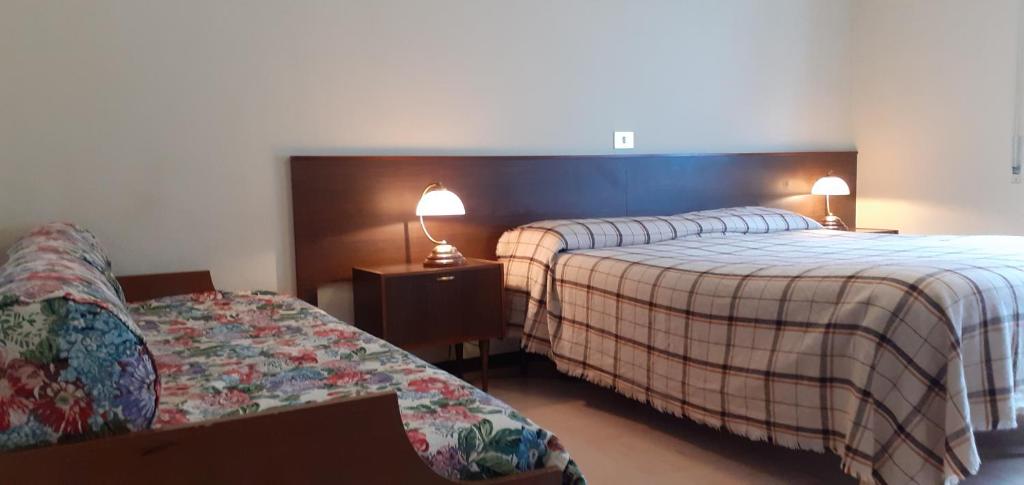 Postel nebo postele na pokoji v ubytování Hotel Cristallo