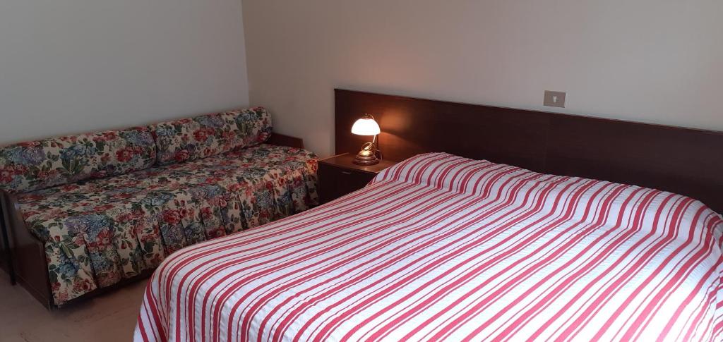 Postel nebo postele na pokoji v ubytování Hotel Cristallo
