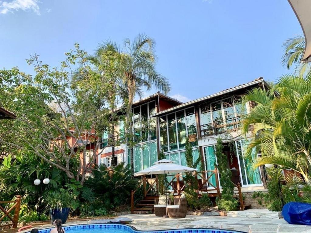 a resort with a swimming pool and a building at Ananda Pousada in Pirenópolis