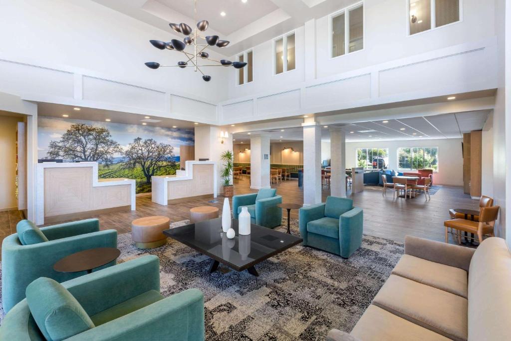 a lobby with blue chairs and a table at La Quinta by Wyndham Paso Robles in Paso Robles
