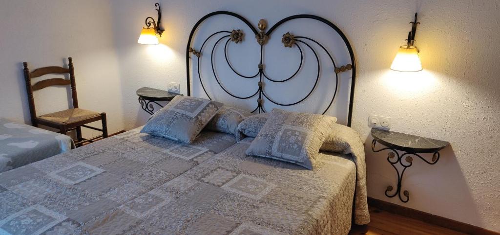 a bedroom with a large bed with two lamps at Casa Les in Les