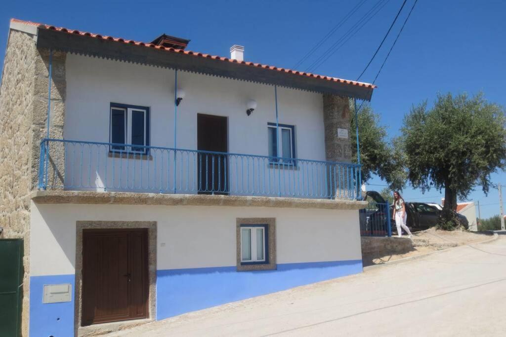 ein blau-weißes Haus mit einem Balkon in der Unterkunft Casa da Rosa Linda in Orca