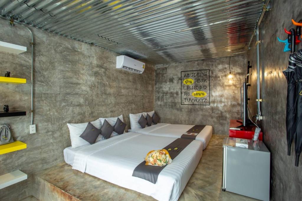 Postel nebo postele na pokoji v ubytování บ้านมะนาวรีสอร์ท เกาะล้าน