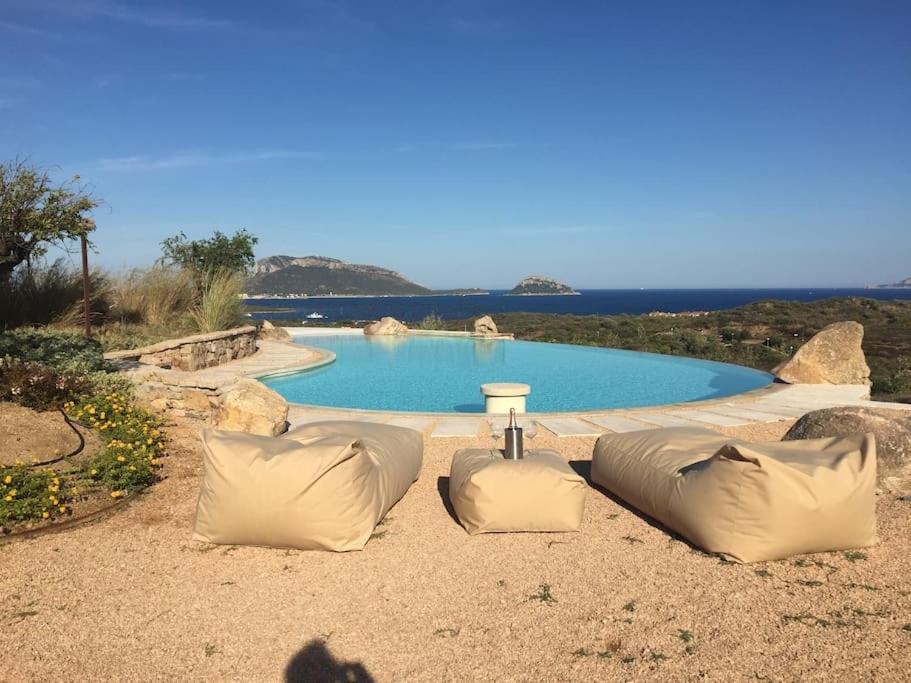 a swimming pool with two pillows in front of it at VILLA VISTA MARE INFINITY POOL in Santa Marinella
