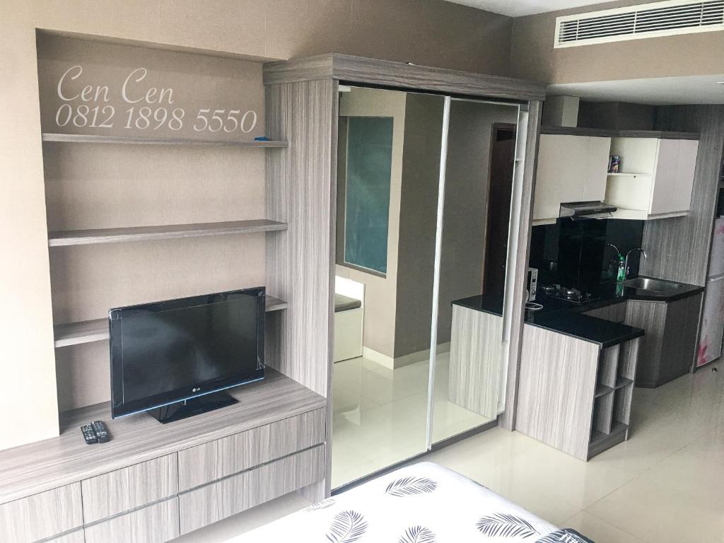 a living room with a flat screen tv on a wall at Near Aryaduta, Siloam Hospital, UPH. U Residence Apartment for Stay in Tangerang