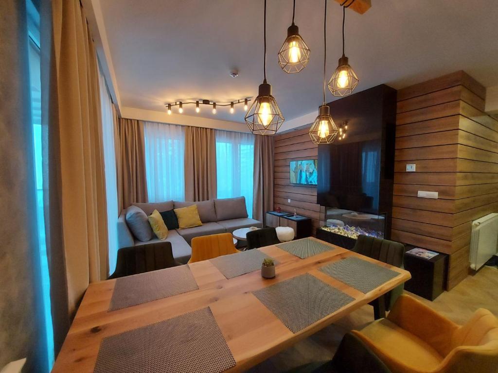 a living room with a table and a couch at Apartmani Winner Jahorina in Jahorina