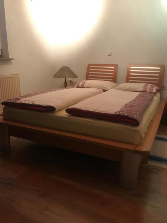a large bed with a wooden frame in a room at Hava 2 in Sarajevo