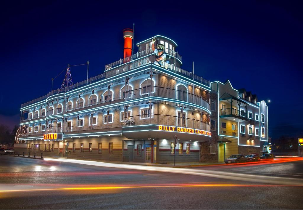 a large building with a lighthouse on top at night at Billy Barker Casino Hotel in Quesnel