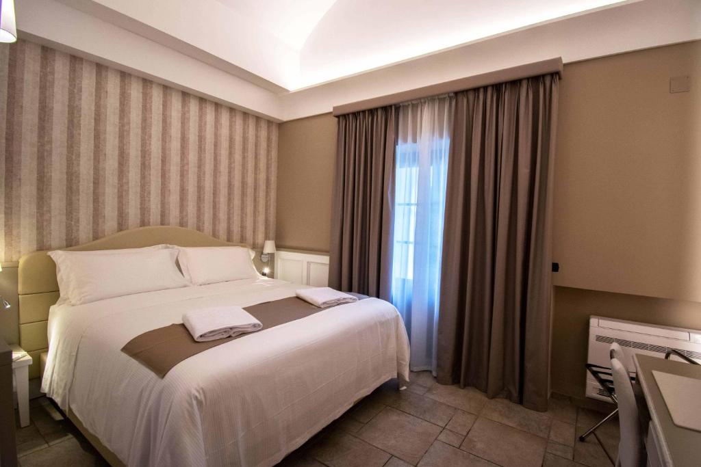 Postel nebo postele na pokoji v ubytování Hotel Parco delle Querce