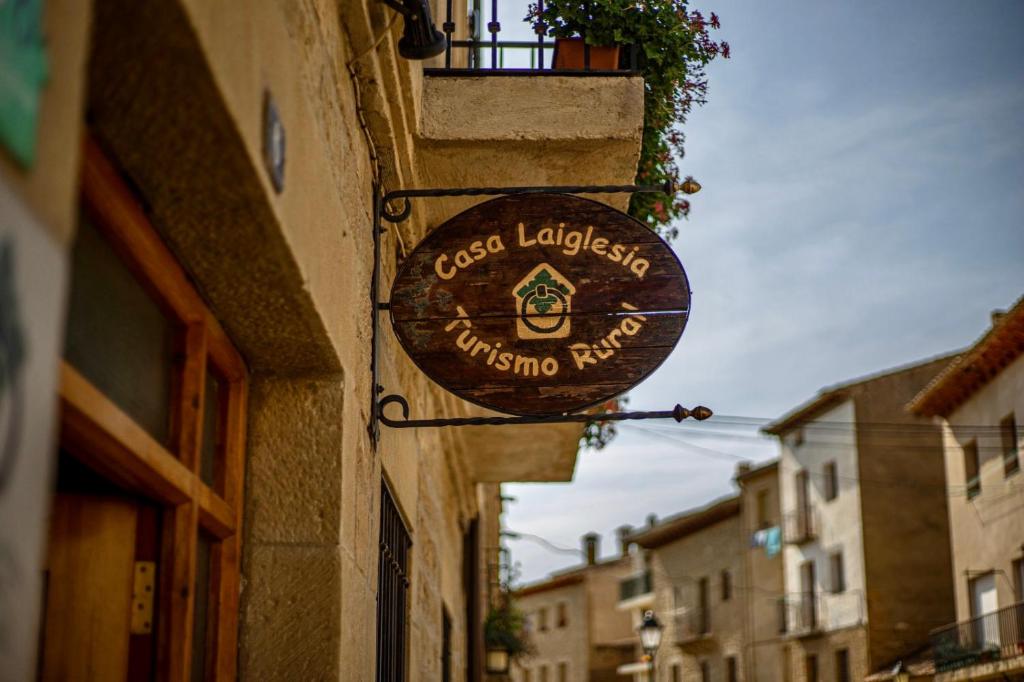 a sign hanging on the side of a building at Casa Laiglesia in Uncastillo