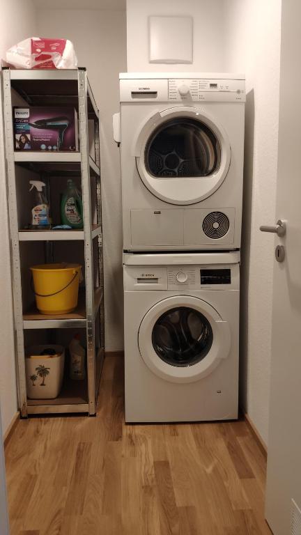 a washer and dryer sitting in a room at Apartment "SUN" in Friedrichshafen