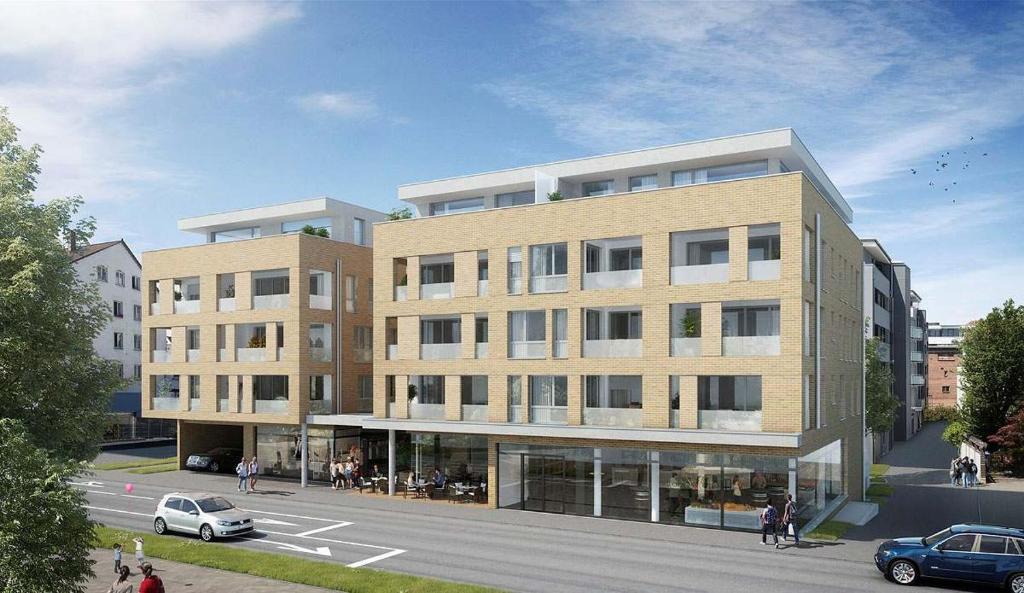 a rendering of a large building on a street at Apartment "SUN" in Friedrichshafen