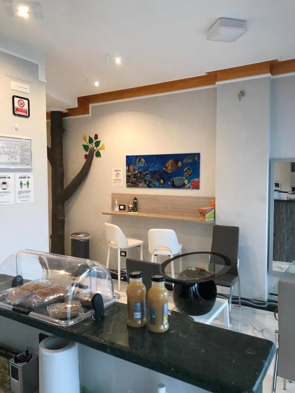 a kitchen with a counter with a table and chairs at Guest House Bracciano RM in Bracciano