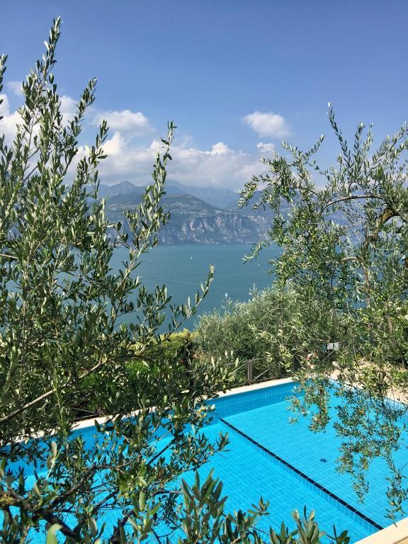 a swimming pool with a view of the water at Appartamento Venzo in Brenzone sul Garda