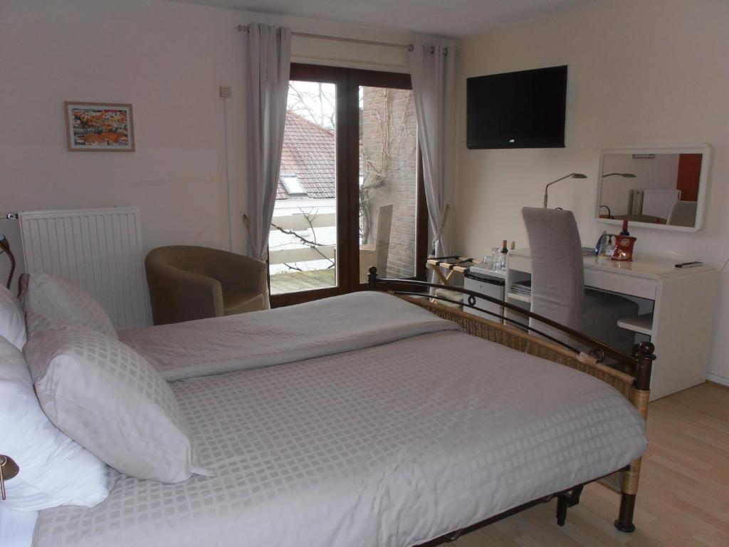Postel nebo postele na pokoji v ubytování B&B Jossefin Tuinen