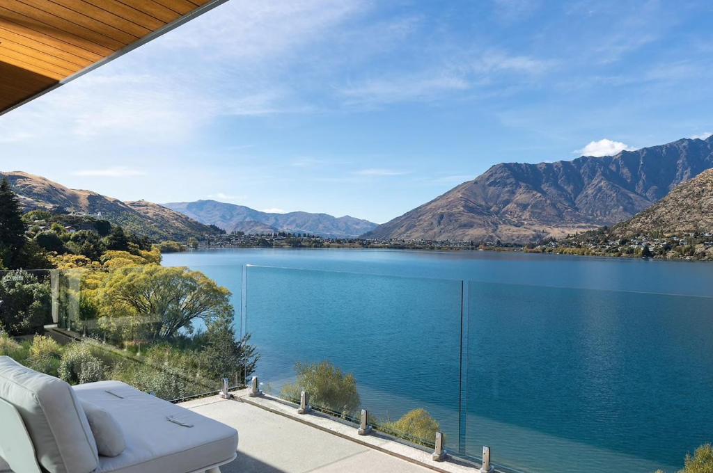 a view of a lake from a house at 'LakeLife' Lake Front Apartment in Queenstown