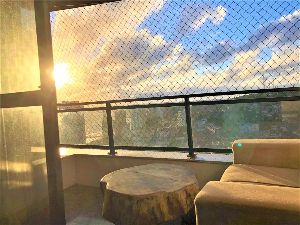 a room with a large window with a coffee table at APARTAMENTO EM NATAL III in Natal