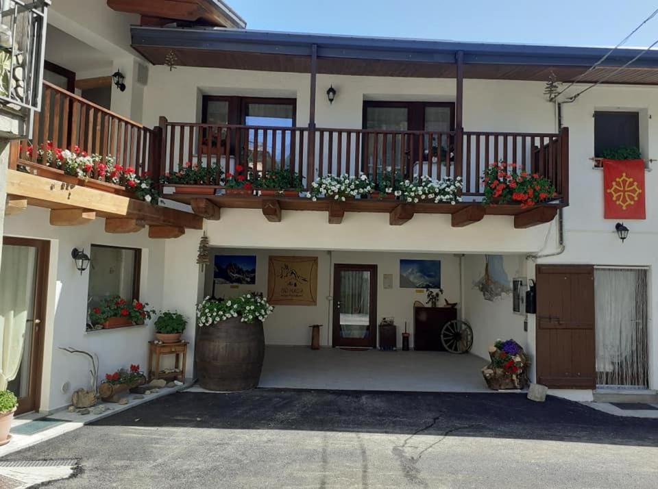 a building with flower boxes and balconies on it at Bio Magia Nelle Marittime in SantʼAnna di Valdieri