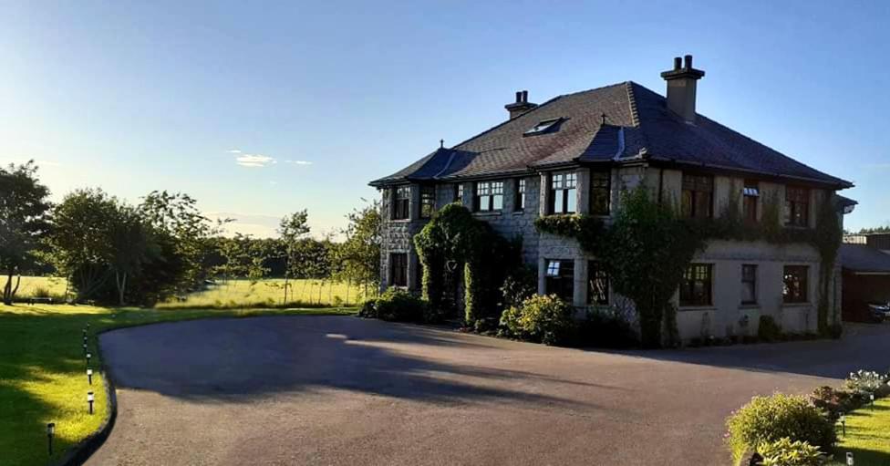 a large house with a driveway in front of it at Bogenraith House in Banchory