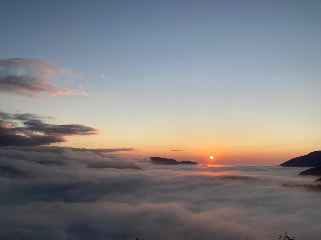 a view of the sun rising over a sea of clouds at Cingjing Brilliant Twins of Seattle in Ren&#39;ai