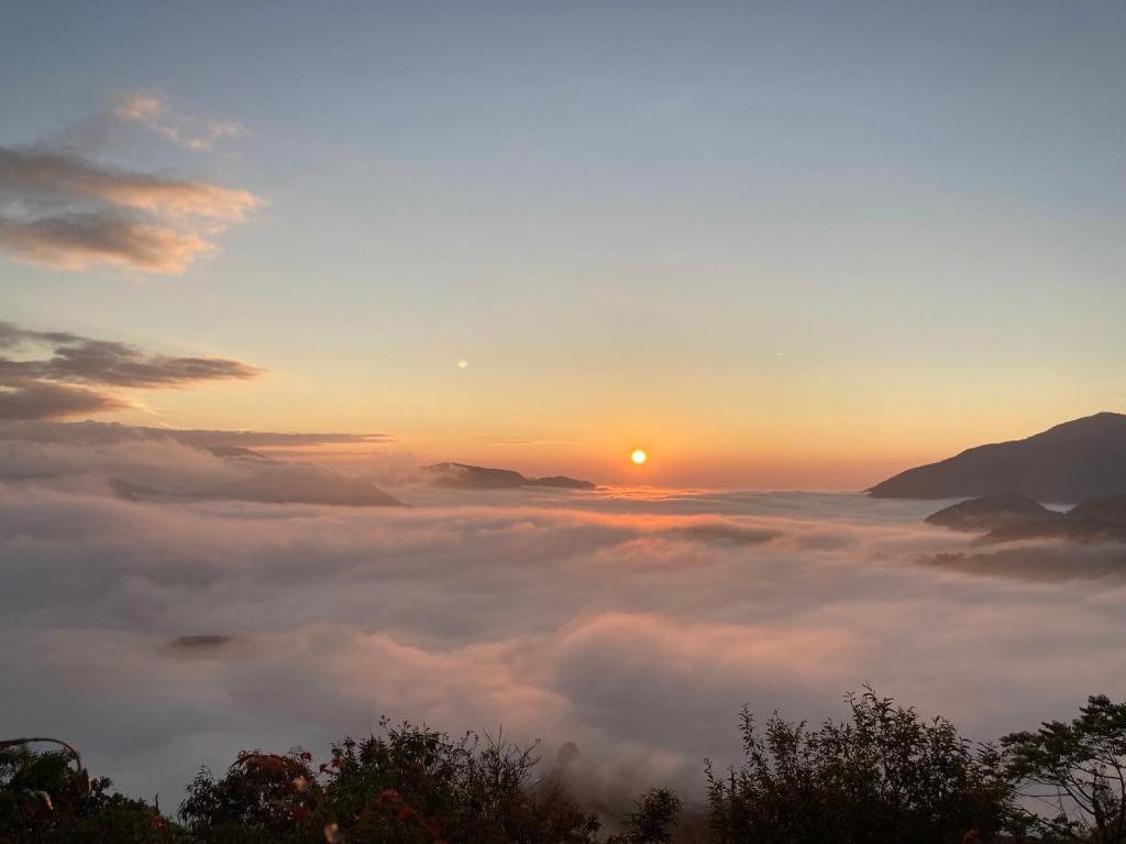 a view of the sun rising above a sea of clouds at Cingjing Brilliant Twins of Seattle in Ren&#39;ai