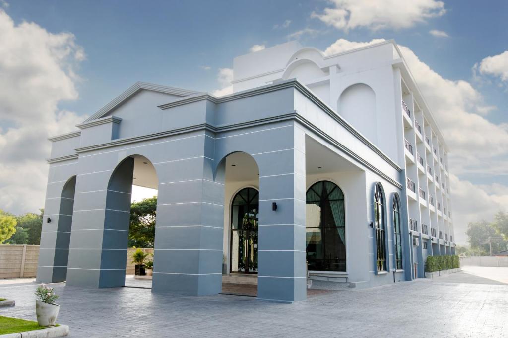 拉差汶里Le Lert Hotel Ratchaburi的一侧有拱门的白色建筑