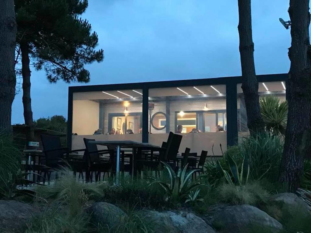 a house with a table and chairs in front of it at Le Theven in Sibiril