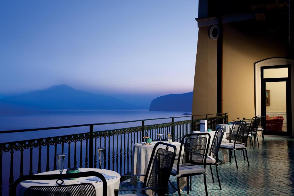 a row of tables and chairs on a balcony at Imperial Hotel Tramontano in Sorrento