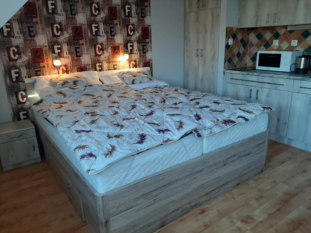 a large bed in a room with at Elit Apartman in Hajdúszoboszló