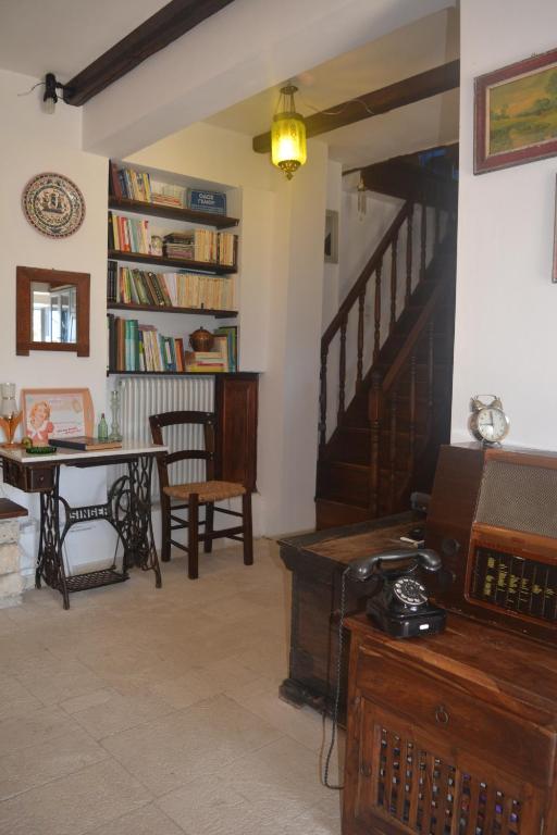 a living room with a staircase and a table at Petrinο Katochori in Katokhórion