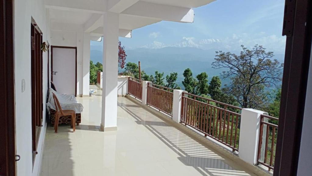 a balcony with a view of the mountains at Janardan Studio Hotel Kausani in Kausani