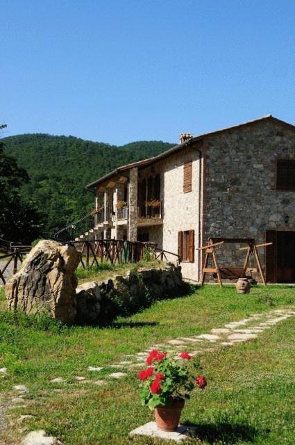 a building with a flower pot in front of it at Agriturismo Villa Martis in Passignano sul Trasimeno