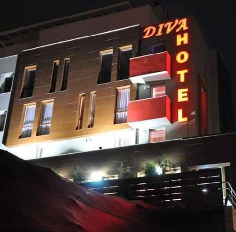 a building with a neon sign on the side of it at Хотел Дива in Blagoevgrad