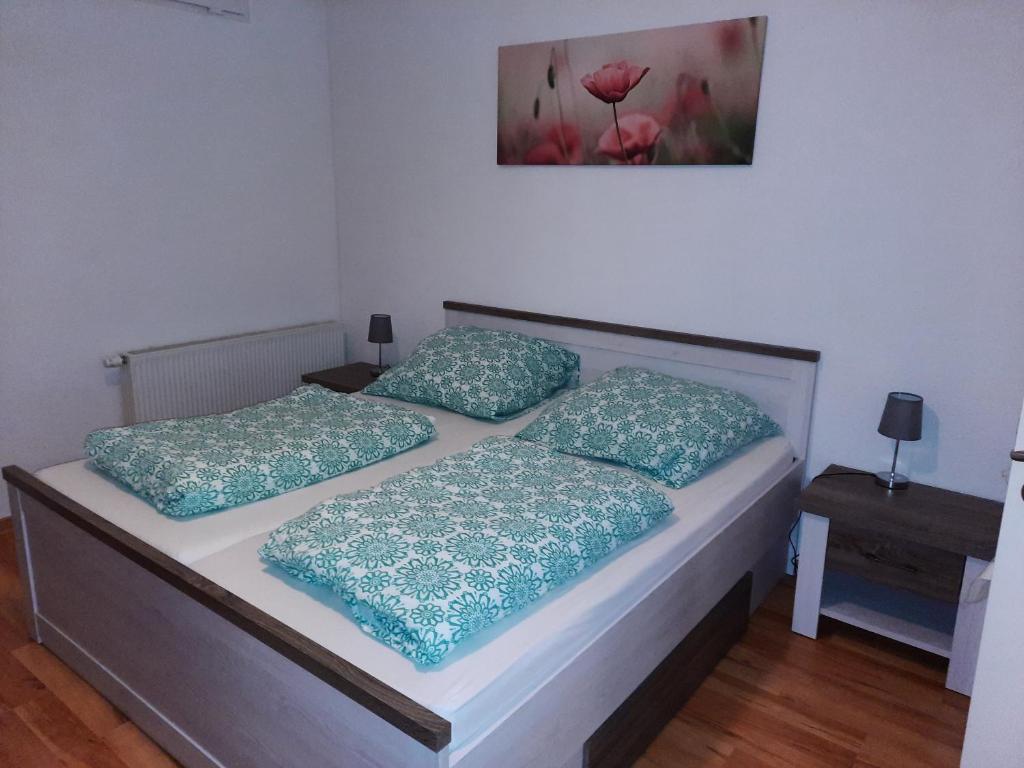 a bedroom with two beds with blue pillows on them at Apartment Wildbad in Bad Wildbad