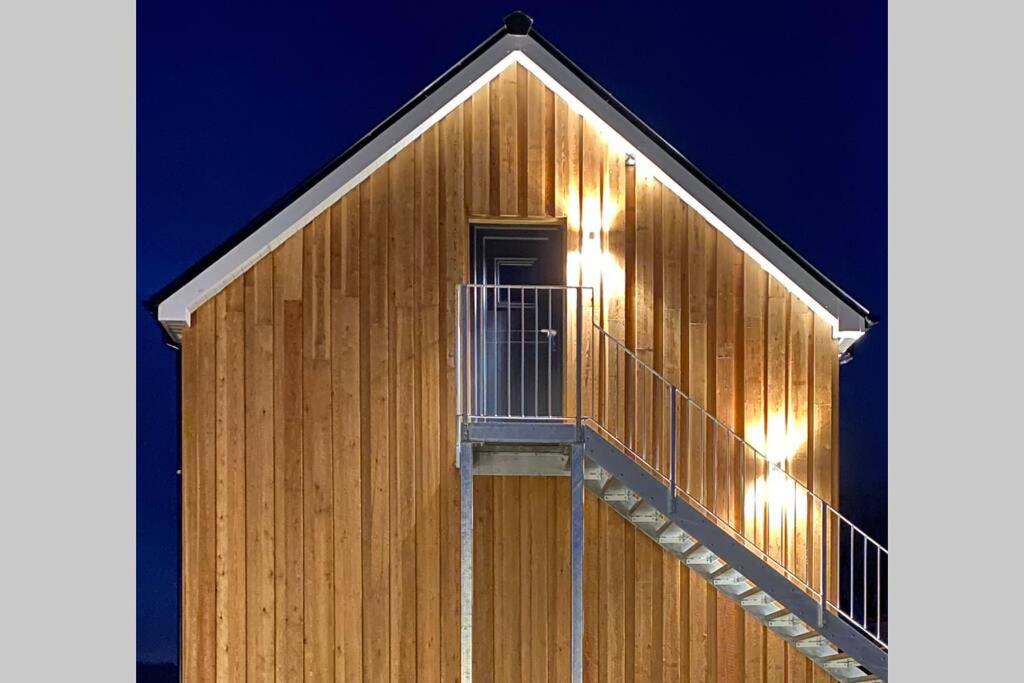 a wooden building with a staircase on the side of it at Prospect Perch - Studio Apartment, Wells in Wells
